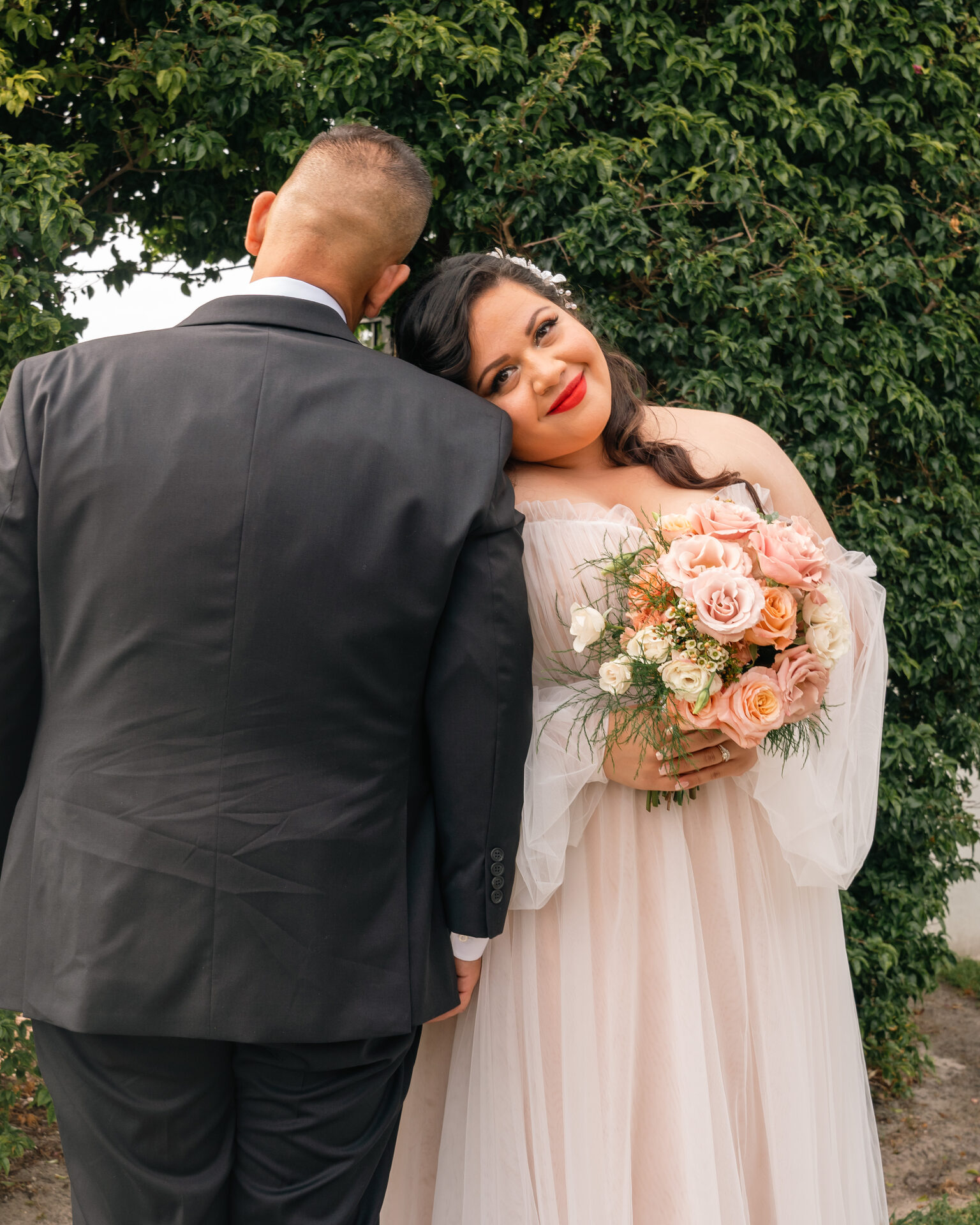 Fine art wedding photography — couple portrait against ivy wall