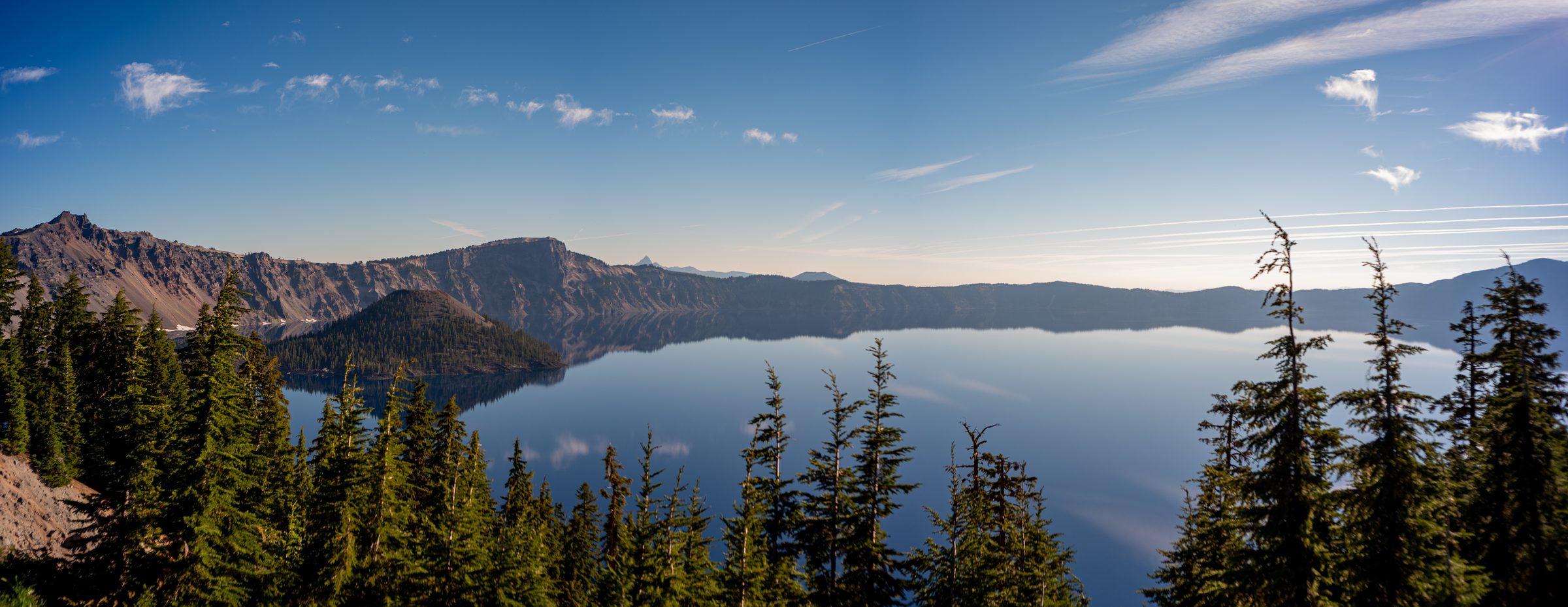 Crater Lake at midday, still water reflecting the sky